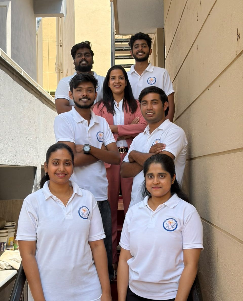 Dr. Rajasree K with her physiotherapy team on the clinic staircase